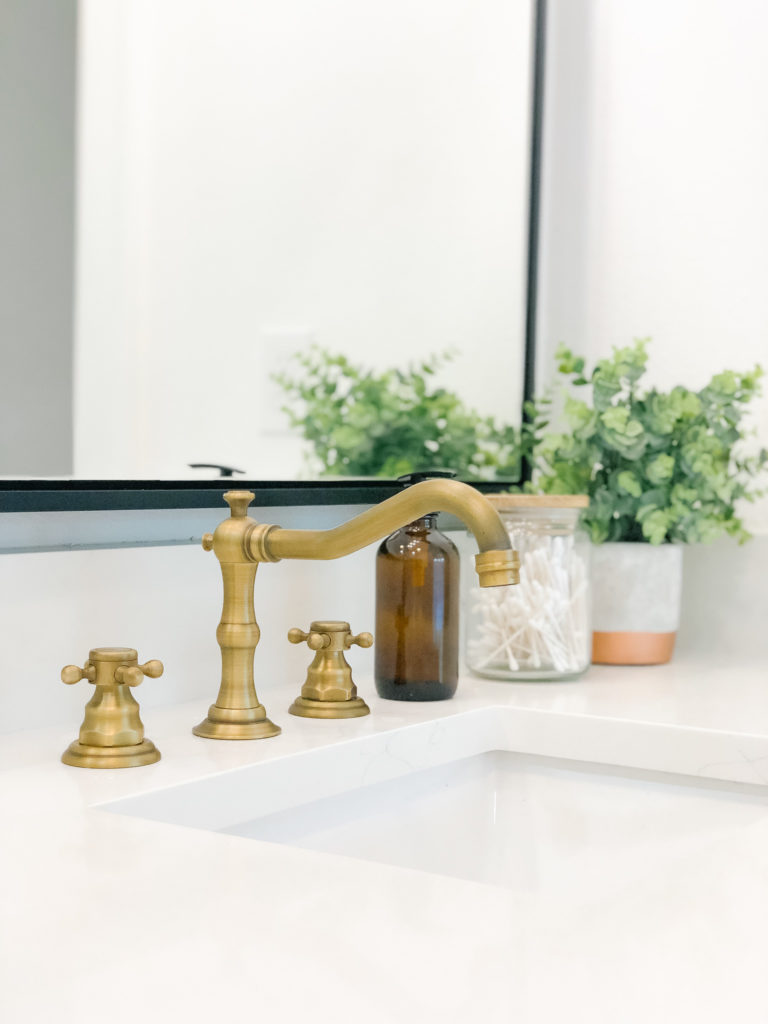 black and white bathroom antique brass faucet quartz countertop | 102-year-old fixer upper house renovation | mid century modern Scandinavian home design | house flip reno